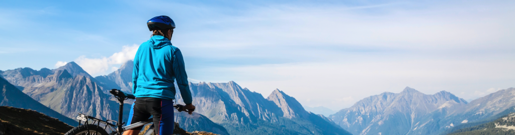 Mountain biker stopped on rocky hillside